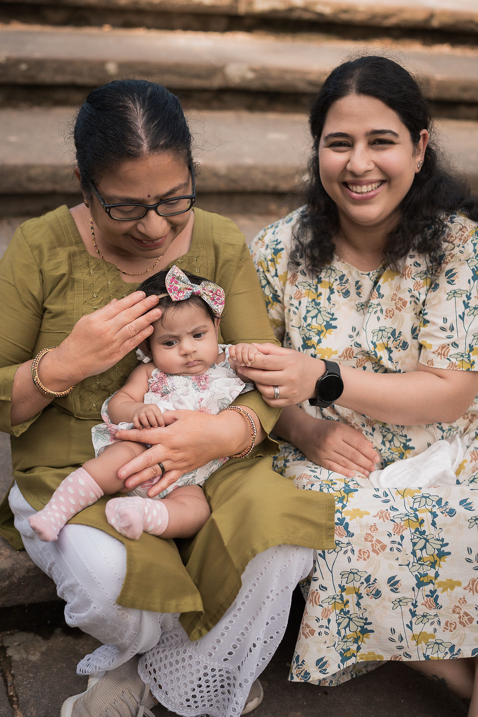 Grandma, mother and baby sitting on the stairs