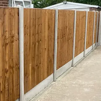 Close-up of dark wooden fencing panels with concrete posts