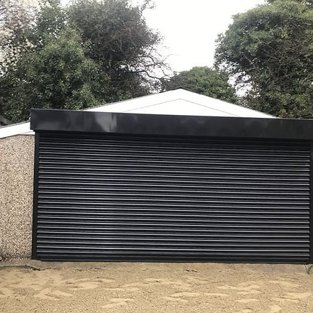 Double wide black roller shutter for a garage