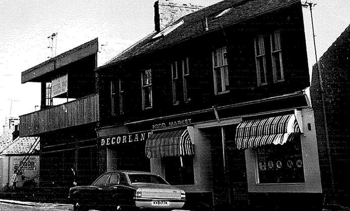 car parked outside Decorland property in the 60s