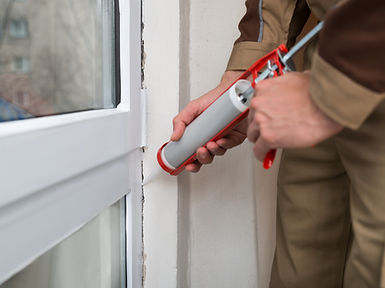 Close-up Of Person Hands Applying Silicone Sealant With Caulking Gun