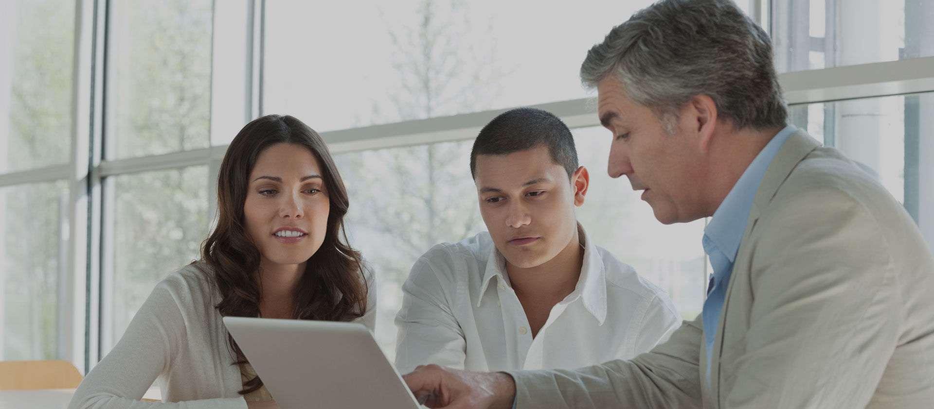 3 people looking at laptop