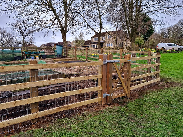 Close-up of wooden fence surrounding garden bed