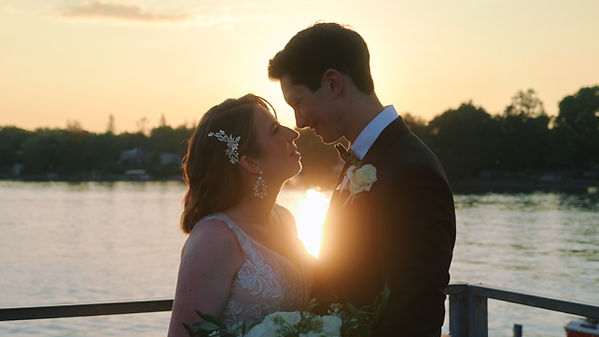 Bride and groom shares a kiss on the Skaneateles Kiss on the Skaneateles Pier on their wedding day