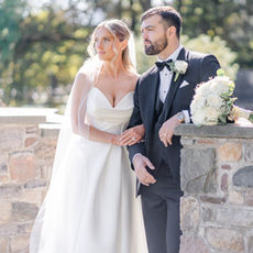 Bride and groom looking out over Skaneateles Lake wedding photo