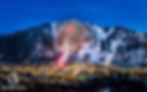Fireworks burst above a snowy mountain town at night, with vibrant reds and greens lighting the sky—text: Advent Jets, Luxury Above the Rest. Aspen