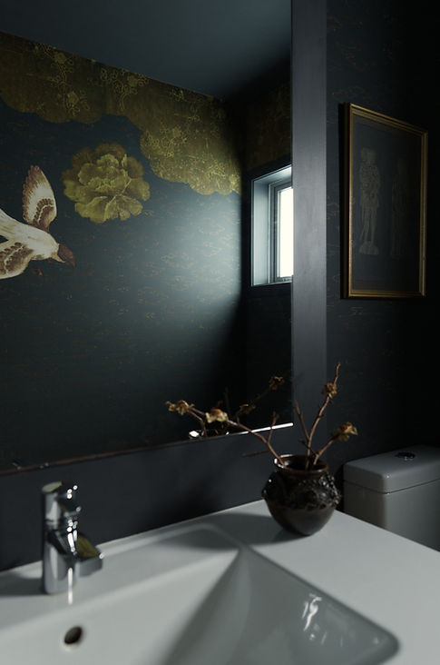 A powder room made moody through Elitis mural wallpaper