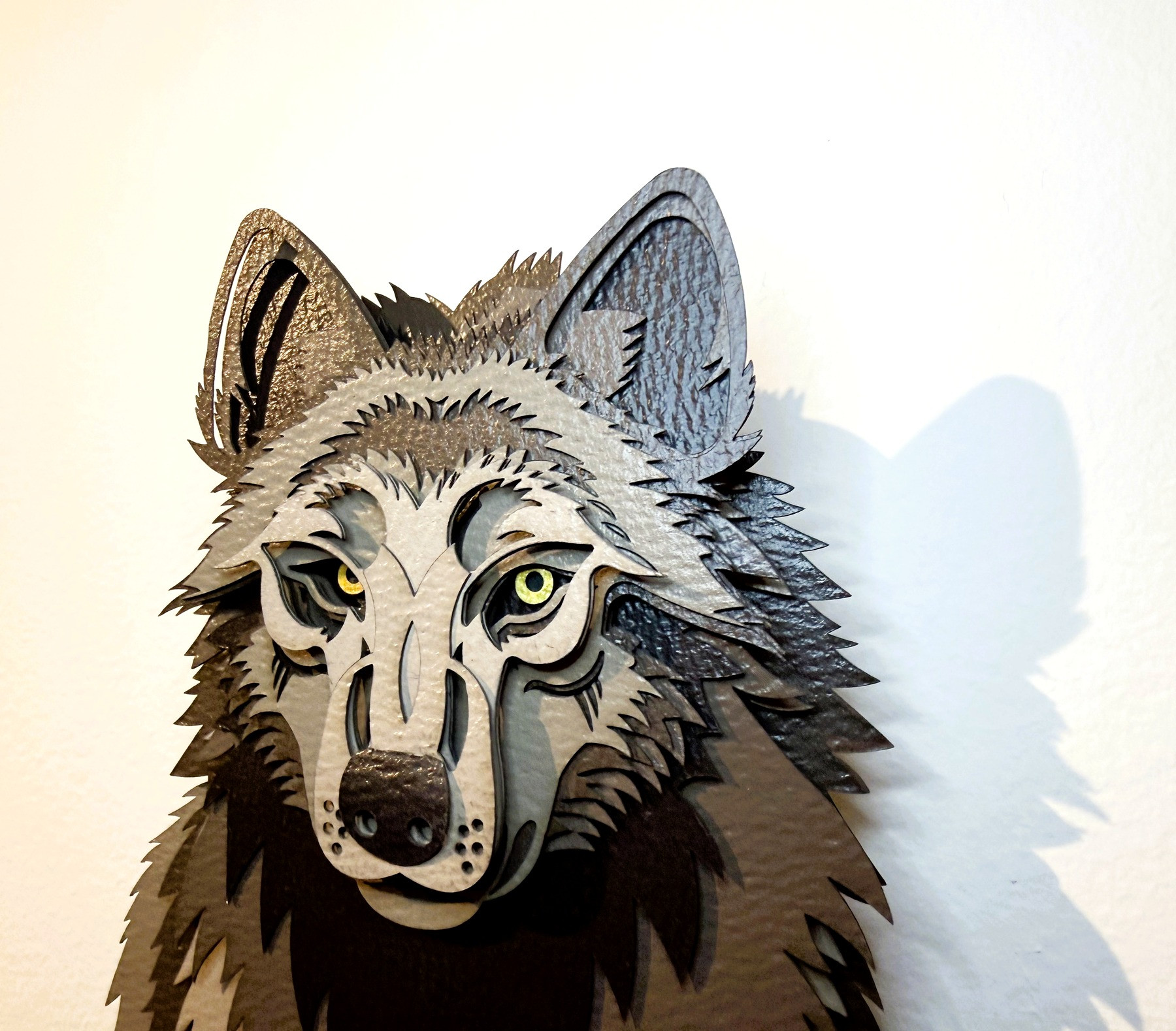 Roman the wolf paper sculpture, front-facing view — hand-painted, CNC-cut wall art from the Something She Remembers series