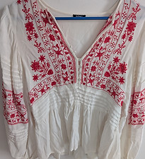 White V-neck blouse with red floral embroidery and gathered waist