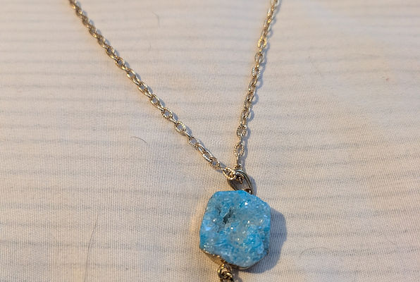 Gold necklace with turquoise stone and tassel