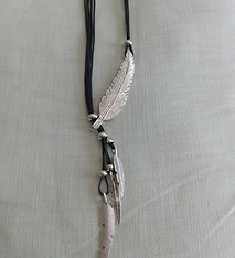 Black cord necklace with two white tusk pendants