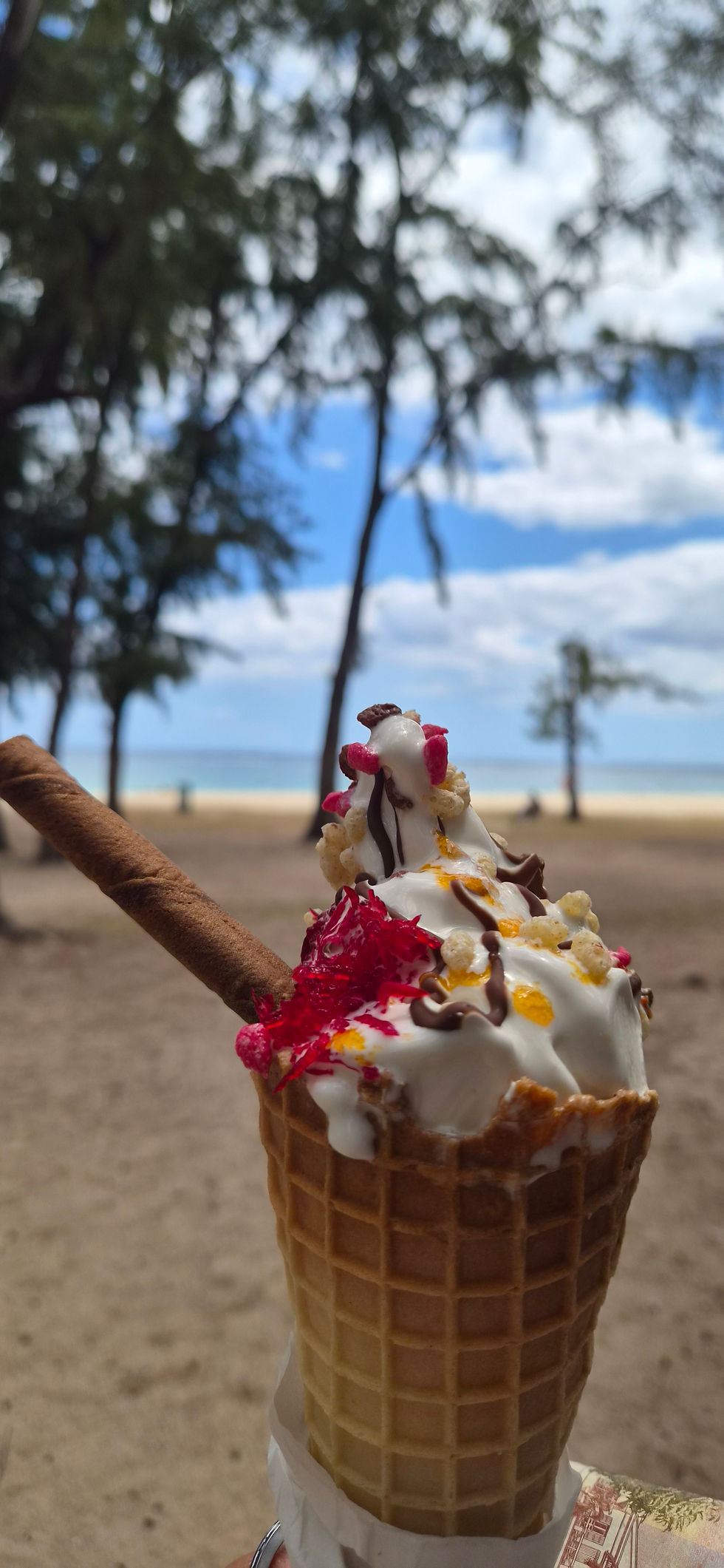 Family enjoying icecream on Flic-en-Flac beach , Mauritius