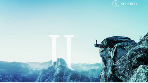 A person stands on a rocky cliff overlooking misty mountains; the sky is blue. Large white "II" and Spherity logo are visible.