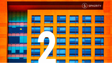 Colorful building facade with blue windows and orange framing. Large white number "2" in center. "SPHERITY" logo in top right corner.