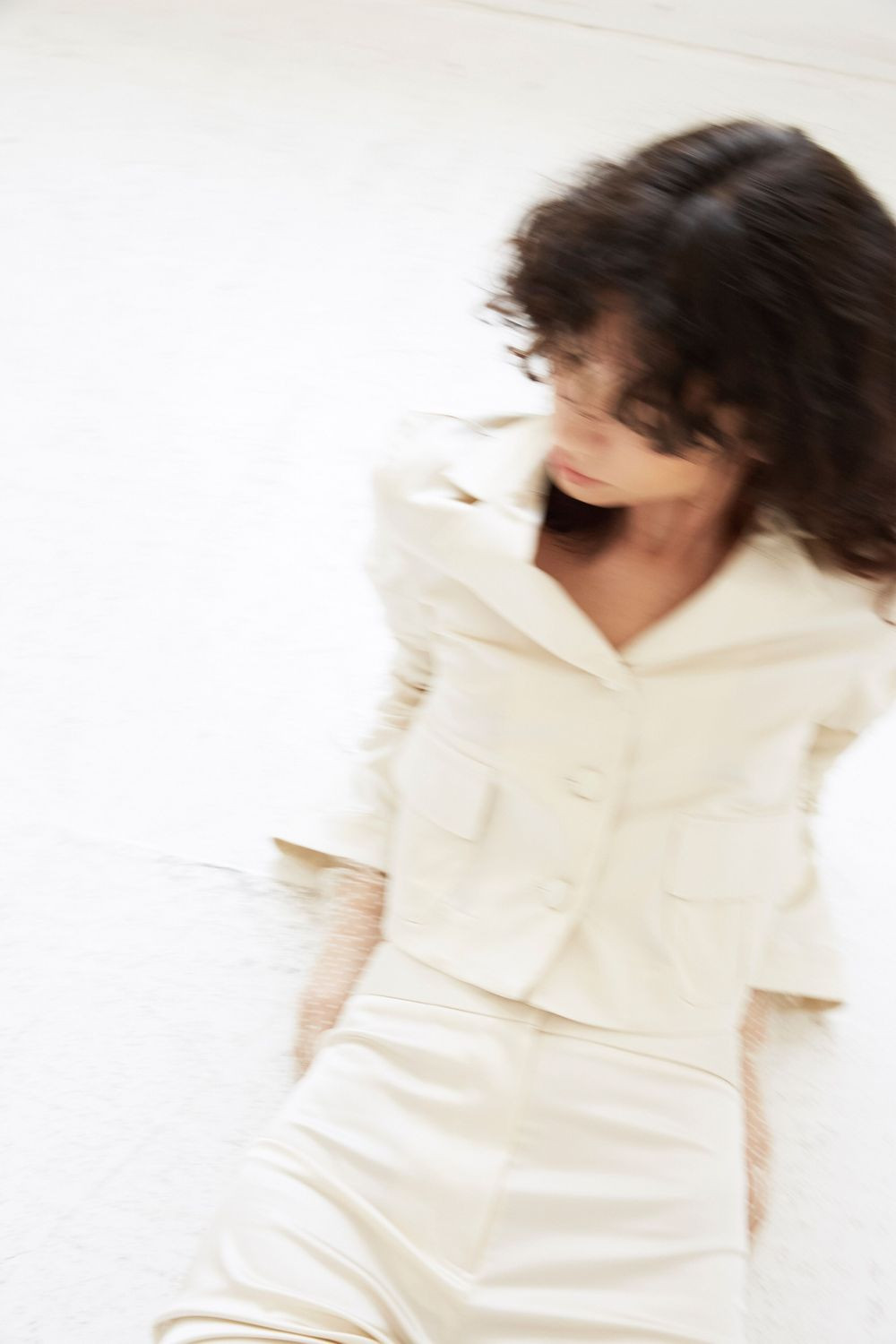 Bride wearing white wedding blazer and satin, flared pants by NY designer Lein.