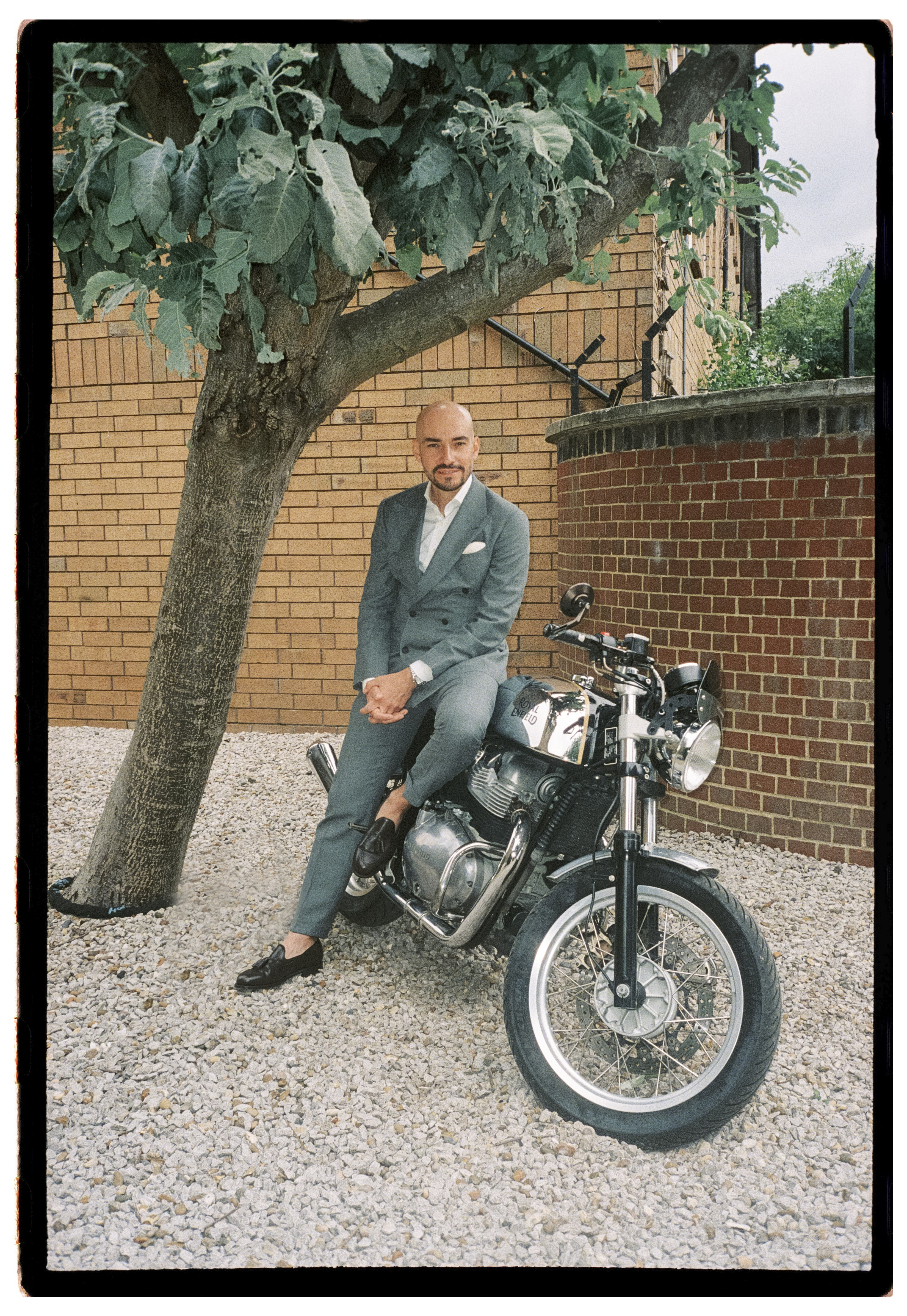Iman in sage green suit with flowers — film editorial wedding photography London