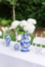 White hydrangeas in blue and white vases at a Wedding Gallery.