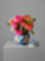 Pink and orange dahlias in a blue wedding gallery ginger jar.