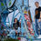 Miniaturbild: Schwarzes T-Shirt mit rockigem Print - Vorderansicht mit Mann und Frau