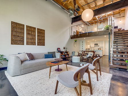 Modern living room with high ceilings and a loft