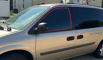 Gold minivan in suburban driveway.png