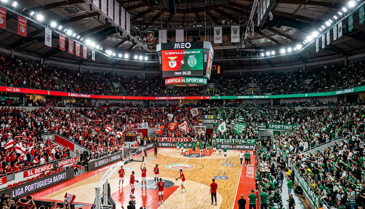 Wide-angle view of a packed European basketball arena before tipoff