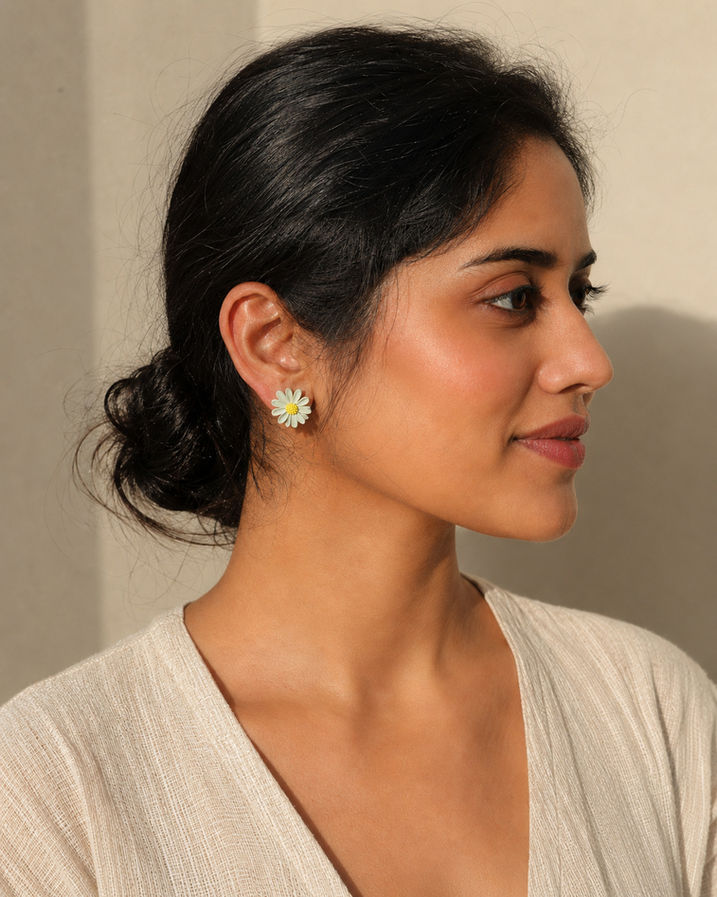 Woman wearing mismatched Korean floral stud earrings