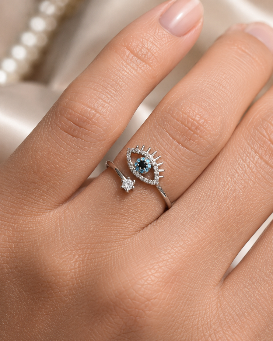 Silver-tone crystal evil eye adjustable ring with blue, black and clear stone detailing