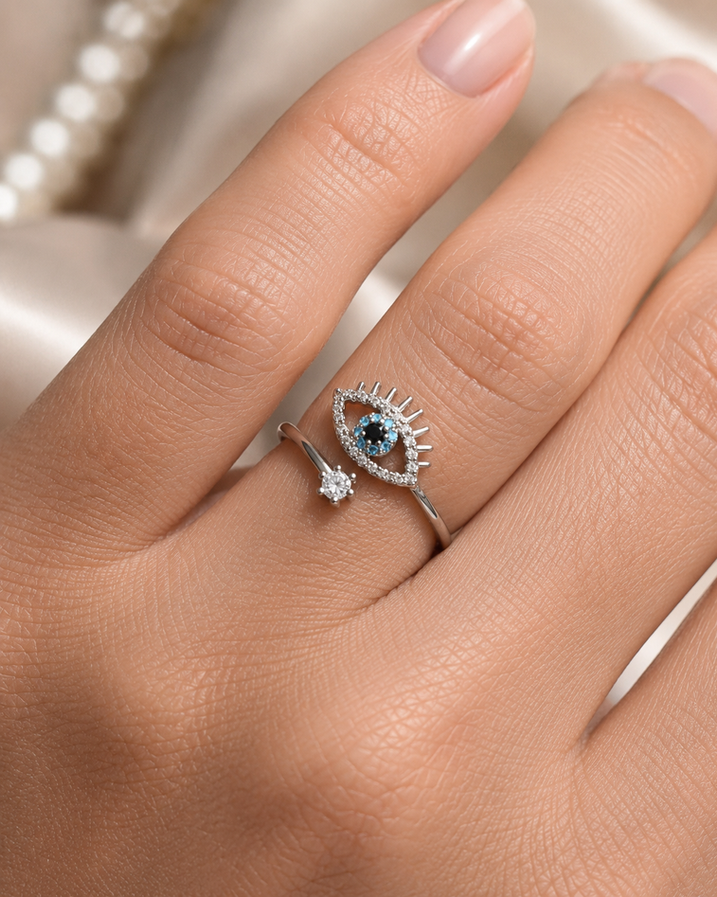 Silver-tone crystal evil eye adjustable ring with blue, black and clear stone detailing