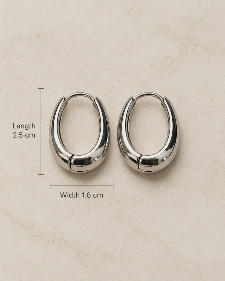 Silver chunky oval hoop earrings pair on jewellery card, minimalist everyday huggies