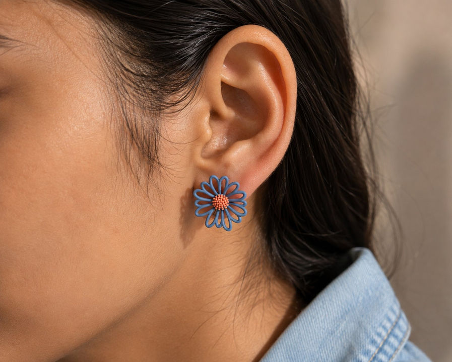 Woman wearing mismatched Korean floral stud earrings in blue