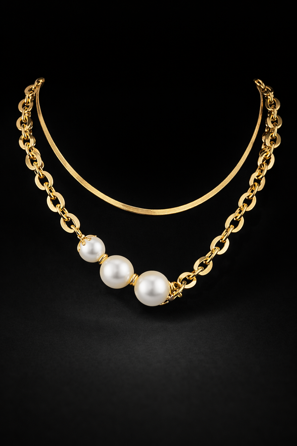 Women’s gold pearl layered statement necklace close-up