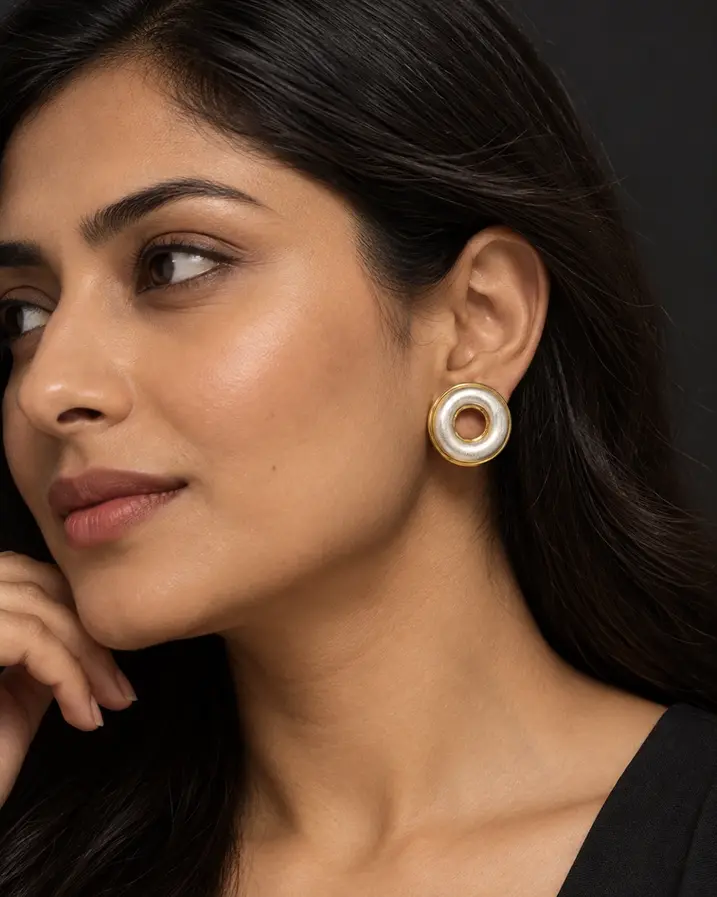 Chunky gold silver mixed metal stud earrings on model