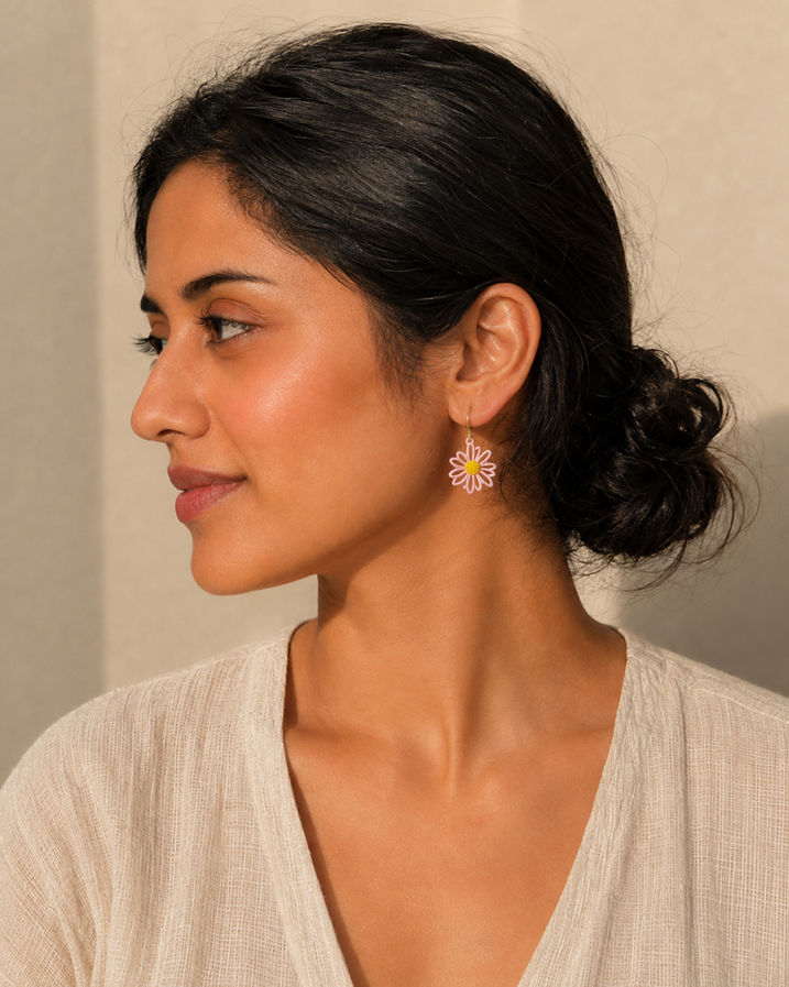 Woman wearing mismatched Korean floral stud earrings