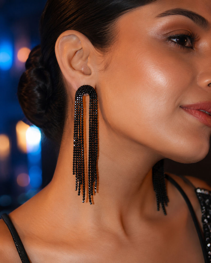 Indian woman wearing Midnight Arc black tassel earrings at an evening party