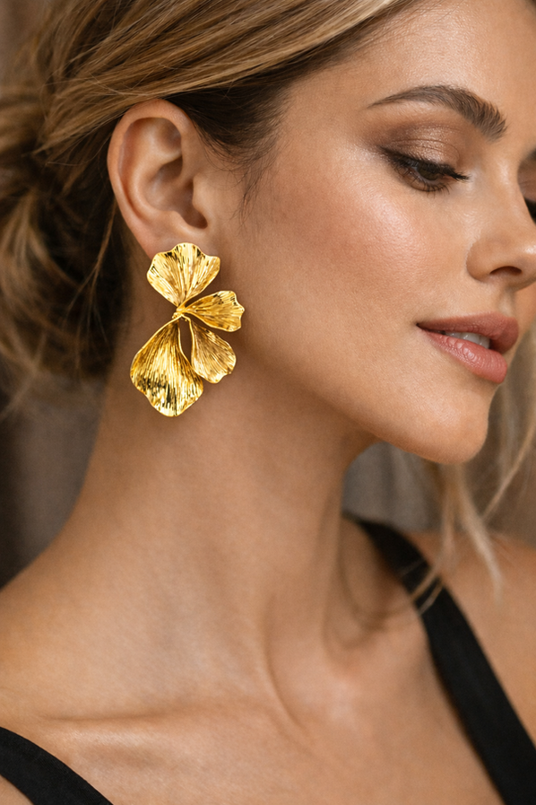 Gold ginkgo leaf statement earrings with textured botanical design