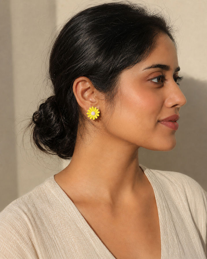 Woman wearing mismatched Korean floral stud earrings