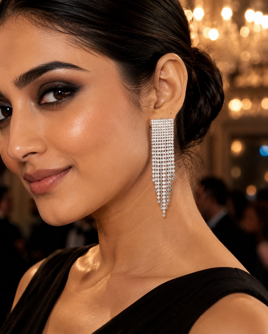 Woman wearing silver crystal waterfall dangler earrings at an evening party
