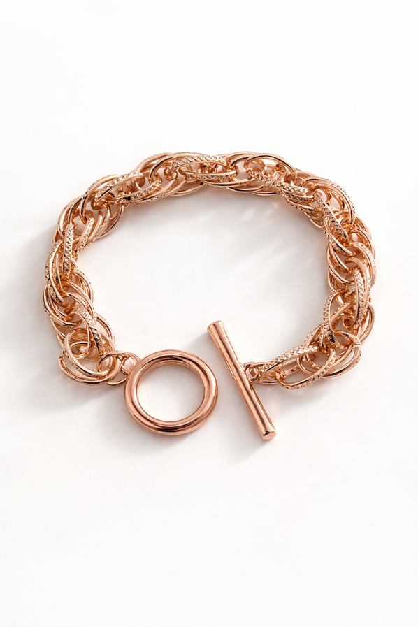 Rose gold chain link bracelet with toggle clasp on white background