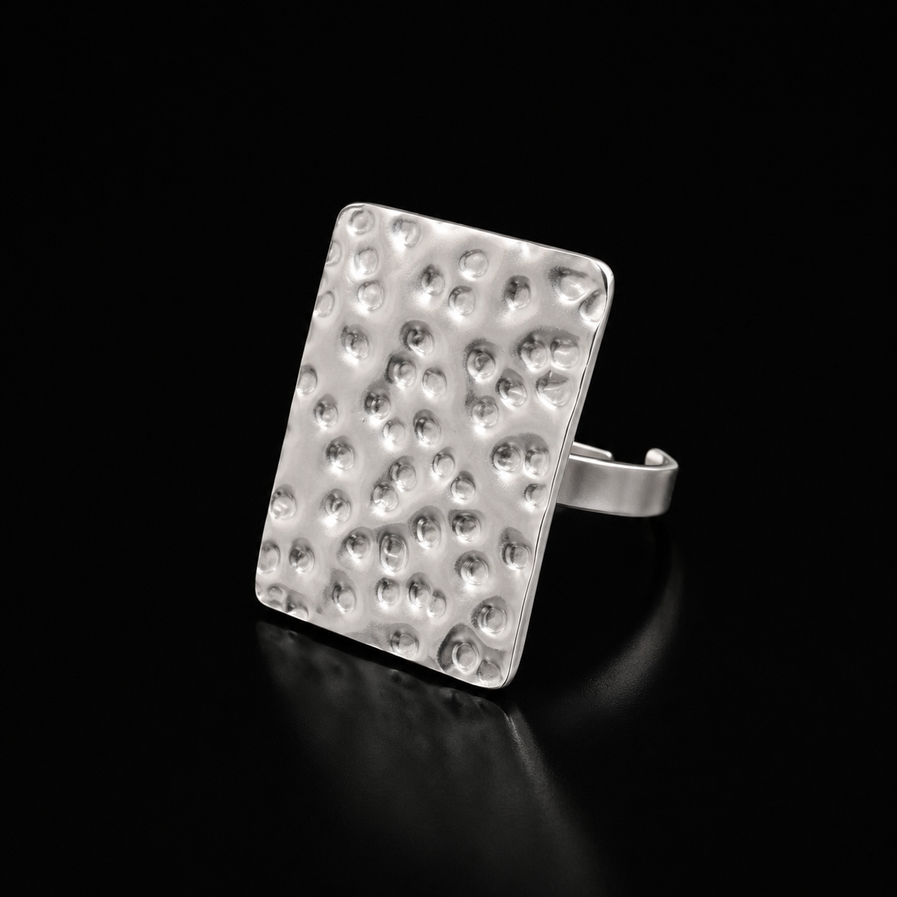 Hammered square face gold ring on dark background