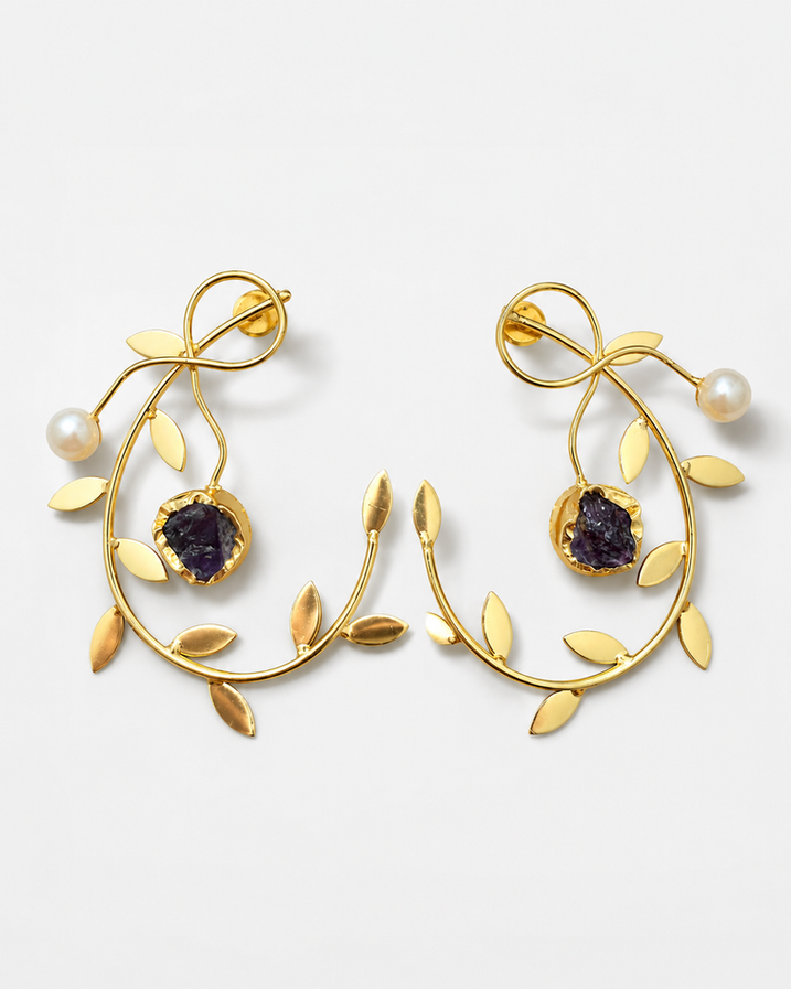 Model wearing gold brass pearl vine earrings with botanical design