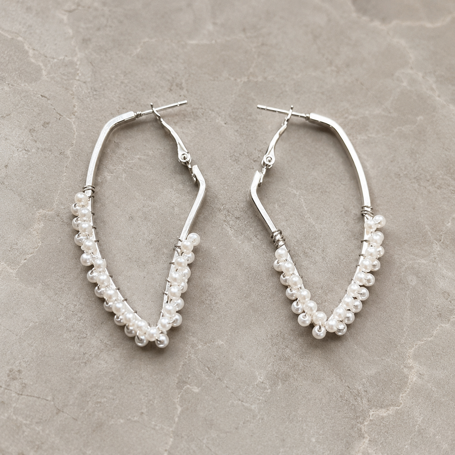 Silver-tone pointed hoop earrings with pearl clusters