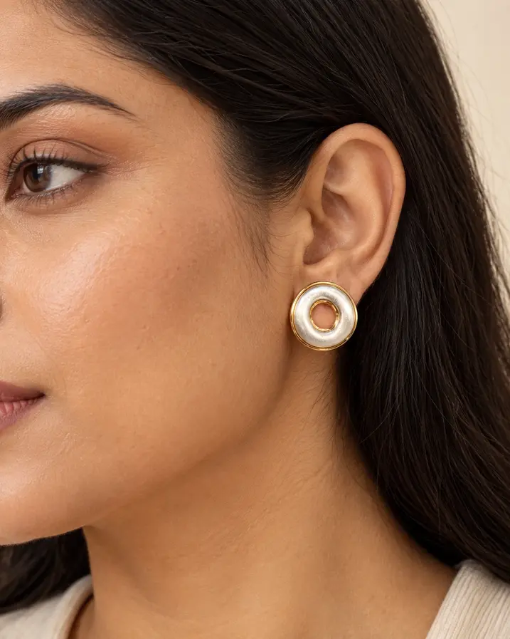 Woman wearing large two tone statement stud earrings