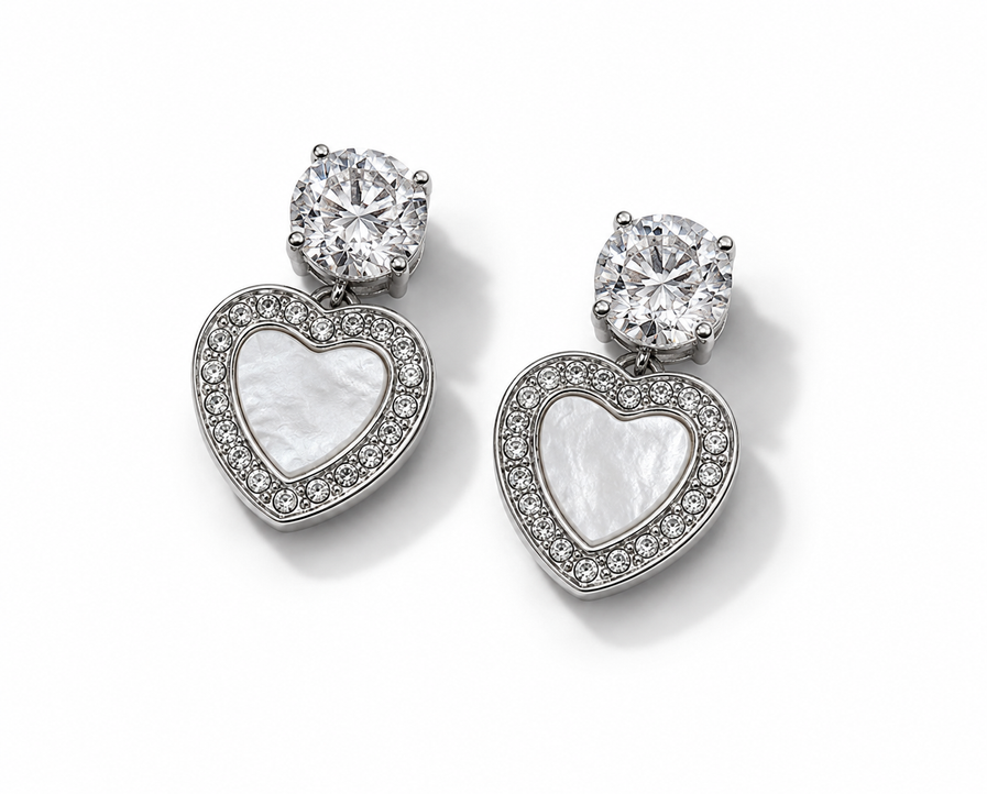 Silver heart stud earrings with sparkling crystal tops, rhinestone heart borders, and white pearl-style heart centers.