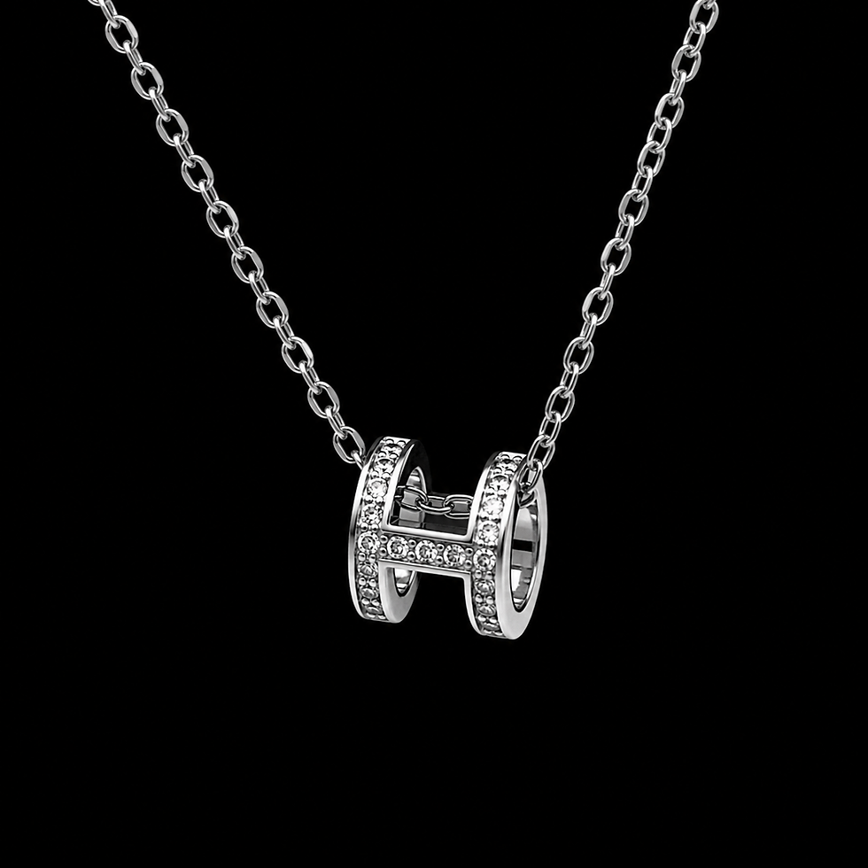 Silver H pendant with a black background