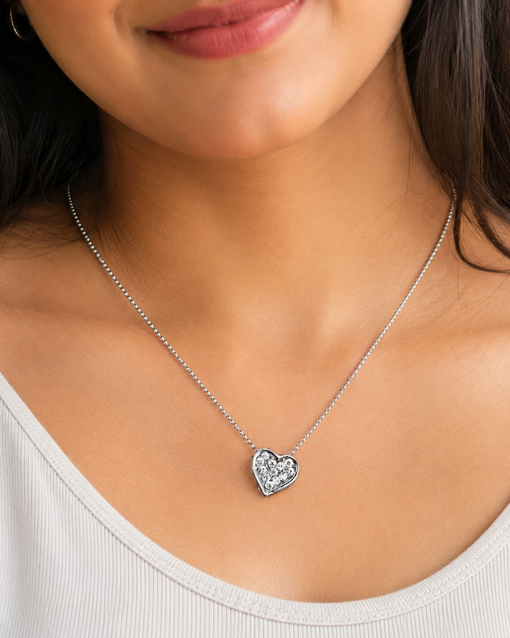 Woman wearing a mini crystal heart pendant necklace