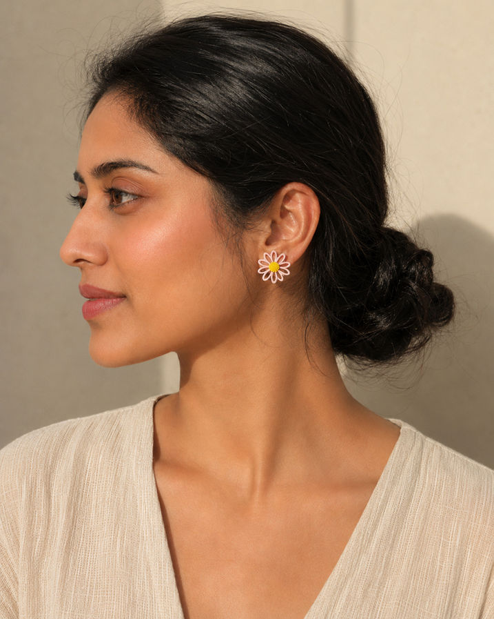 Woman wearing mismatched Korean floral stud earrings