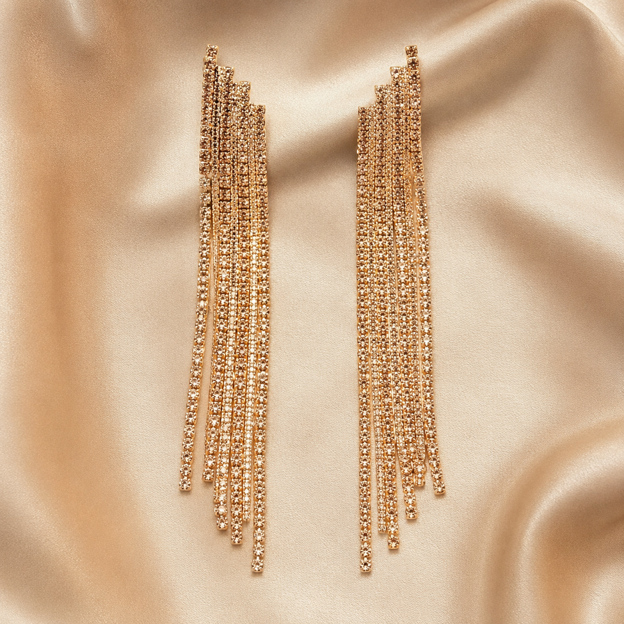 Golden CZ statement dangler earrings on a black background