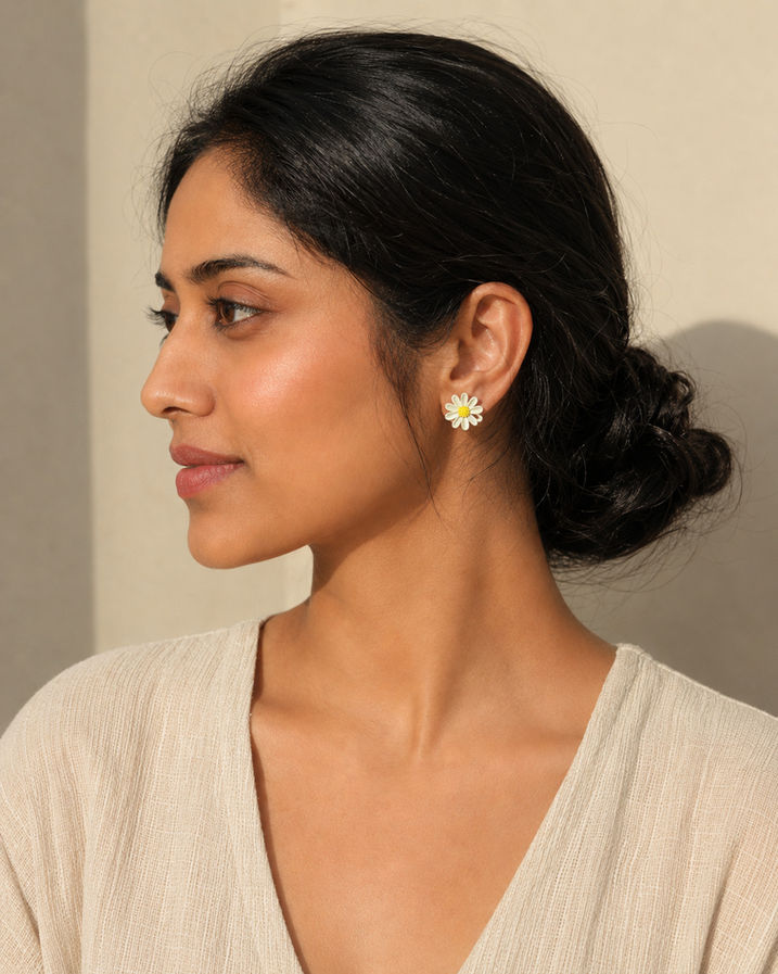 Woman wearing mismatched Korean floral stud earrings