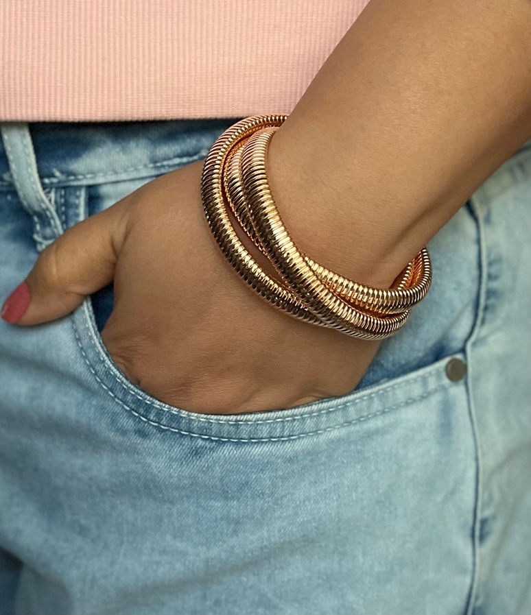 Woman wearing gold coil wrap bracelet with casual denim outfit